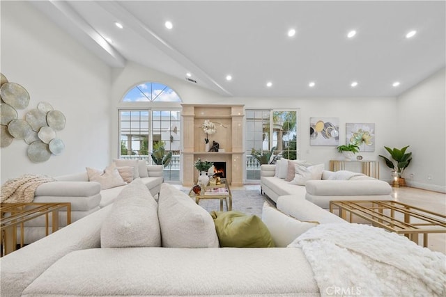 living room with lofted ceiling, a lit fireplace, and recessed lighting