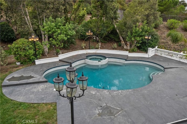 view of swimming pool featuring a patio area and a pool with connected hot tub