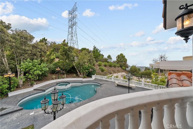 view of pool with a pool with connected hot tub