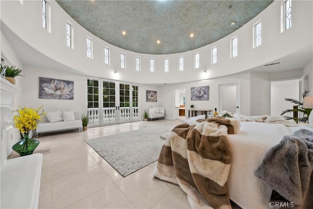 bedroom with visible vents, french doors, and a high ceiling