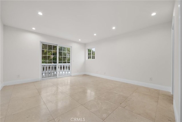 empty room with recessed lighting and baseboards