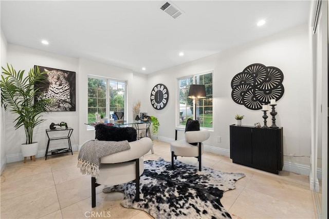 living area with recessed lighting, visible vents, a wealth of natural light, and light tile patterned flooring