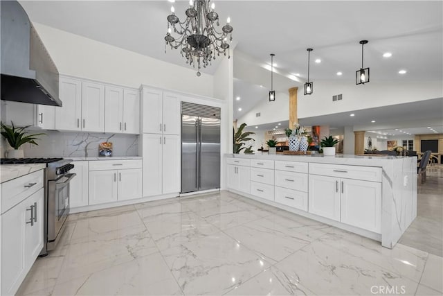 kitchen with marble finish floor, stainless steel appliances, white cabinets, a peninsula, and exhaust hood