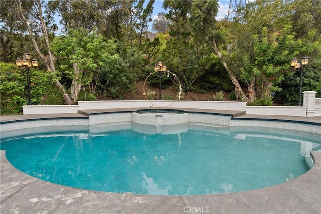 view of swimming pool with a pool with connected hot tub