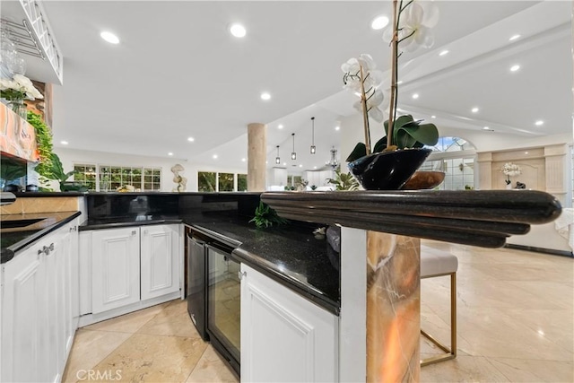 kitchen with a breakfast bar, white cabinetry, and recessed lighting