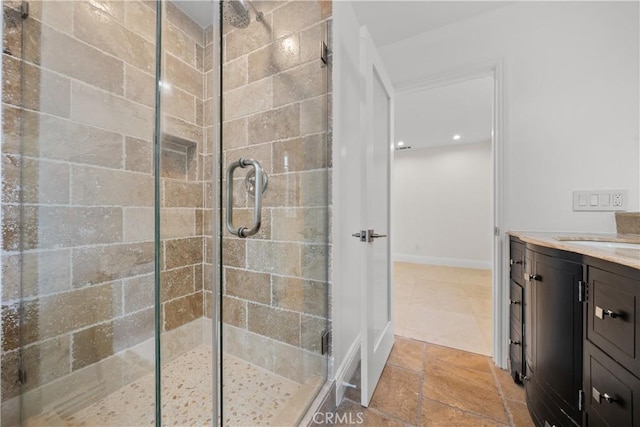 bathroom featuring a shower stall and vanity