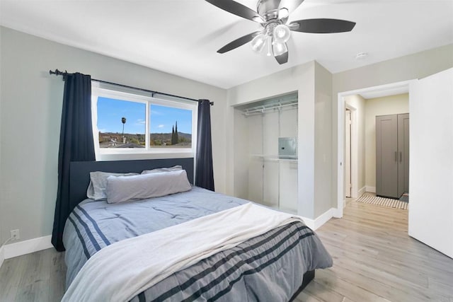 bedroom featuring baseboards, a closet, and light wood-style floors