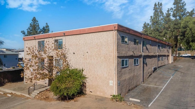 view of side of property featuring stucco siding