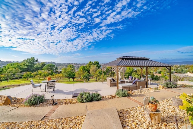 view of property's community featuring a gazebo, an outdoor living space, and a patio