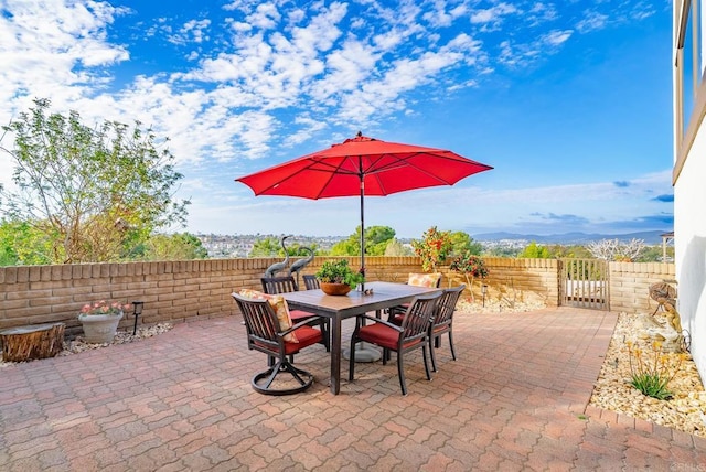 view of patio with outdoor dining space and a fenced backyard