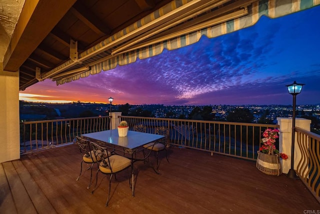 deck at dusk with outdoor dining area