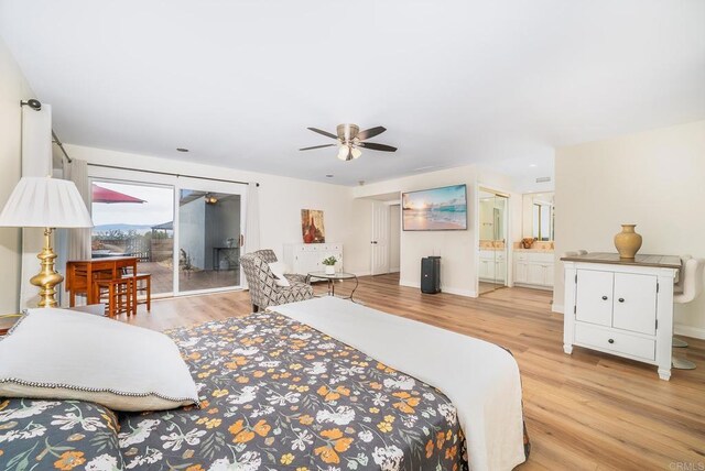 bedroom featuring light wood-type flooring, baseboards, ensuite bath, and access to outside