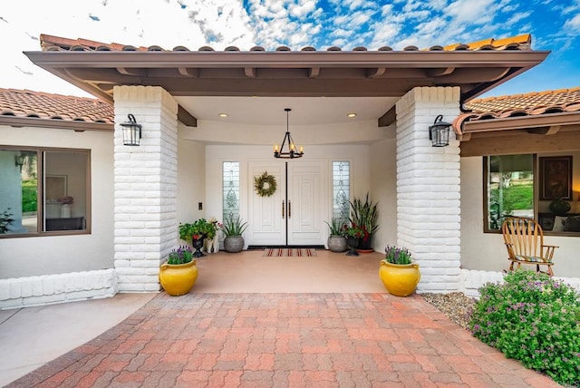 view of exterior entry featuring a tile roof