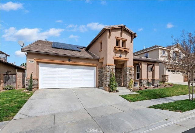 view of front of property with a garage, driveway, stone siding, roof mounted solar panels, and a front lawn