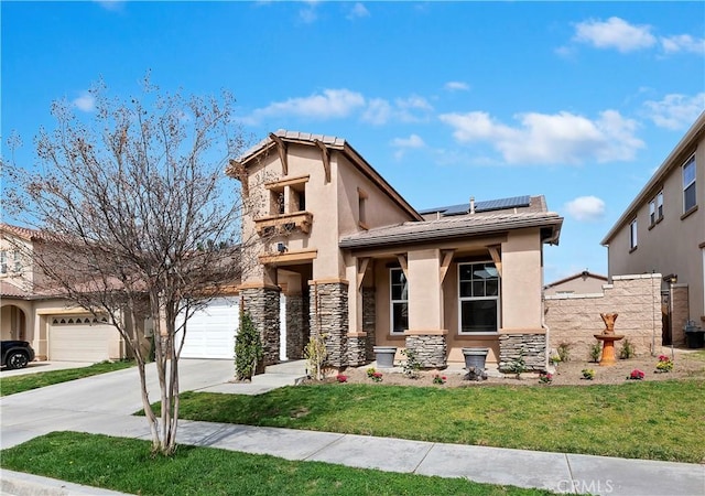 view of front facade featuring driveway, solar panels, stone siding, a front yard, and stucco siding