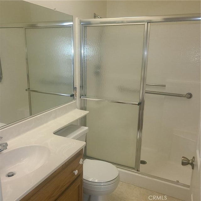 bathroom featuring a stall shower, vanity, and toilet