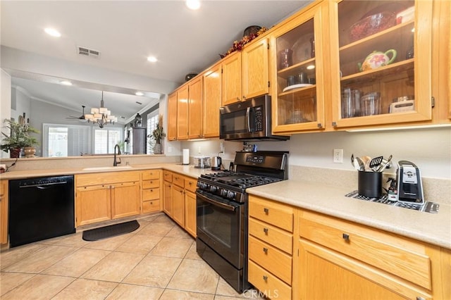 kitchen with a sink, visible vents, vaulted ceiling, light countertops, and black appliances