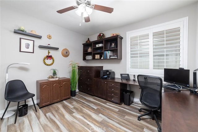 office space featuring light wood-type flooring, a ceiling fan, and baseboards