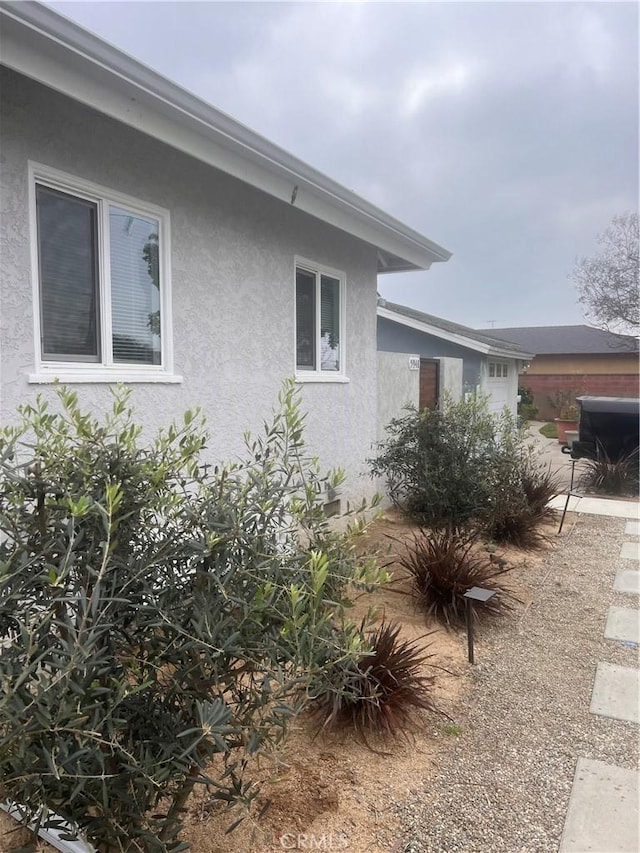 view of side of home with stucco siding