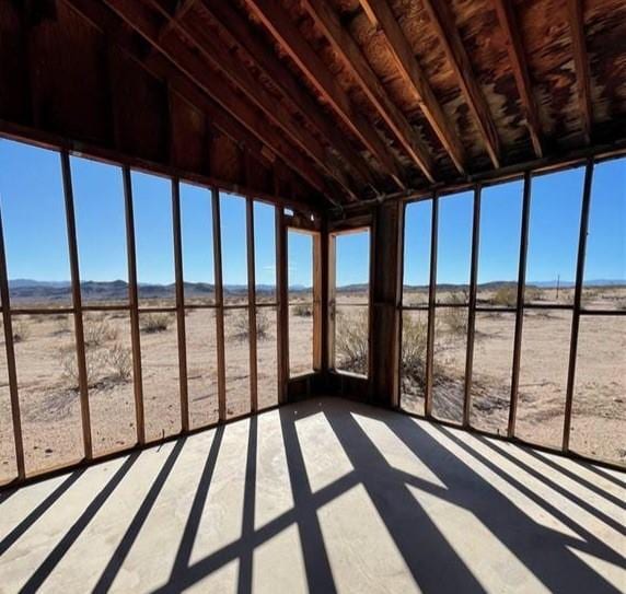 unfurnished sunroom with vaulted ceiling