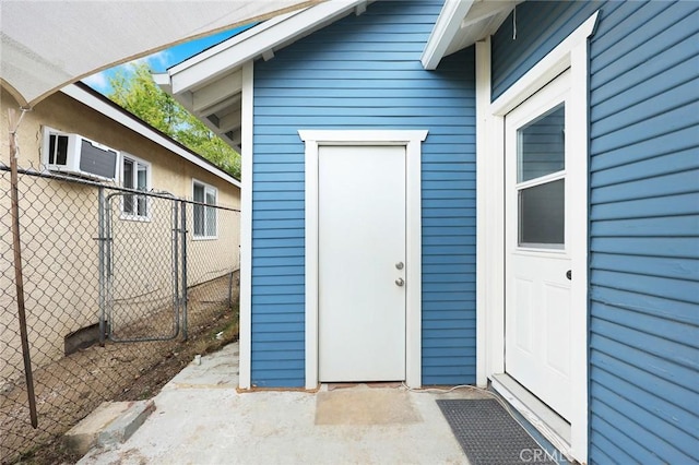 entrance to property featuring fence