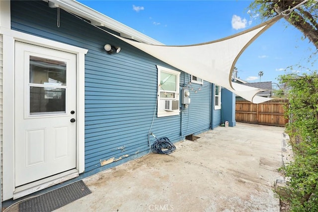 exterior space with a patio area, fence, and cooling unit