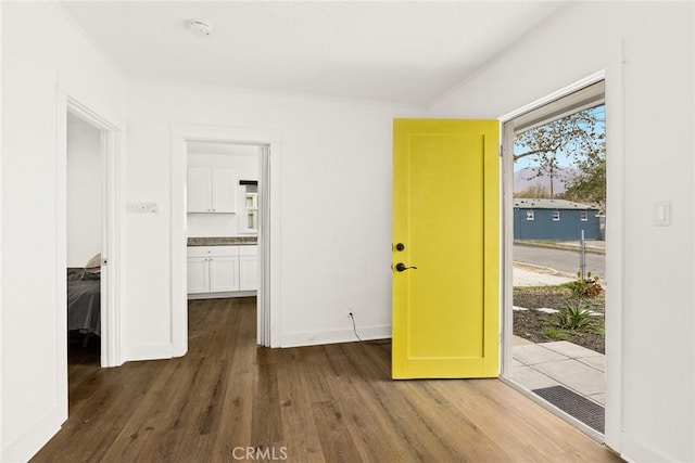 interior space featuring baseboards, visible vents, and wood finished floors