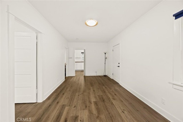 hall featuring wood finished floors and baseboards