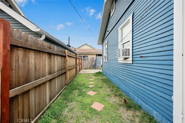 view of yard featuring cooling unit and fence