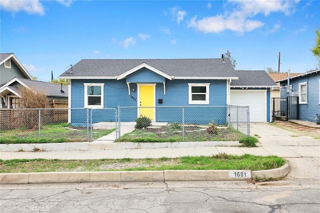 view of front of home with a fenced front yard, concrete driveway, roof with shingles, and an attached garage