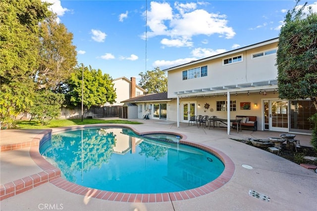 view of pool featuring a patio, french doors, fence, and a fenced in pool