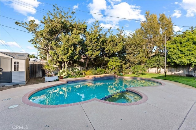 view of swimming pool featuring a pool with connected hot tub and a fenced backyard