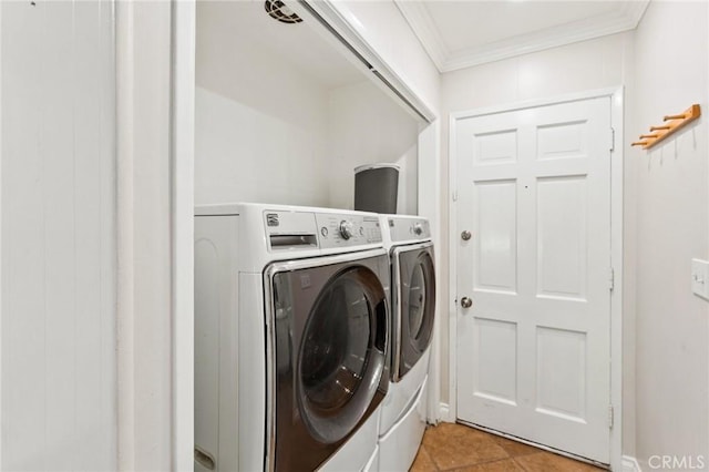 laundry area with ornamental molding and washer and clothes dryer