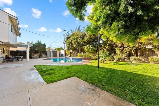 view of swimming pool with an outbuilding, a patio, a fenced backyard, a lawn, and a shed