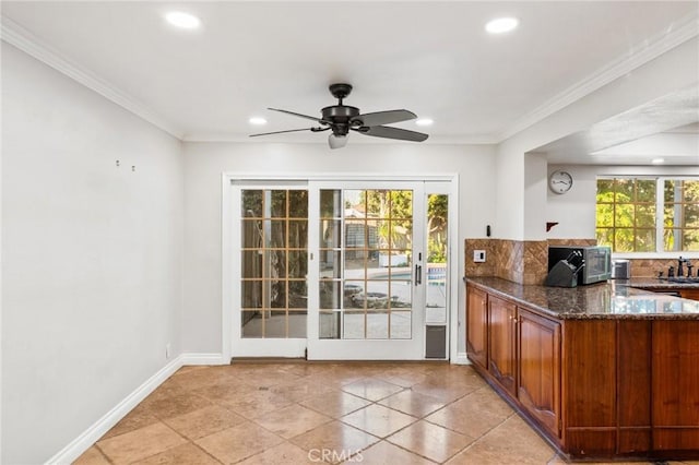 interior space with crown molding, recessed lighting, a ceiling fan, and baseboards