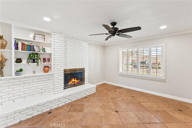 unfurnished living room with a brick fireplace, crown molding, and baseboards