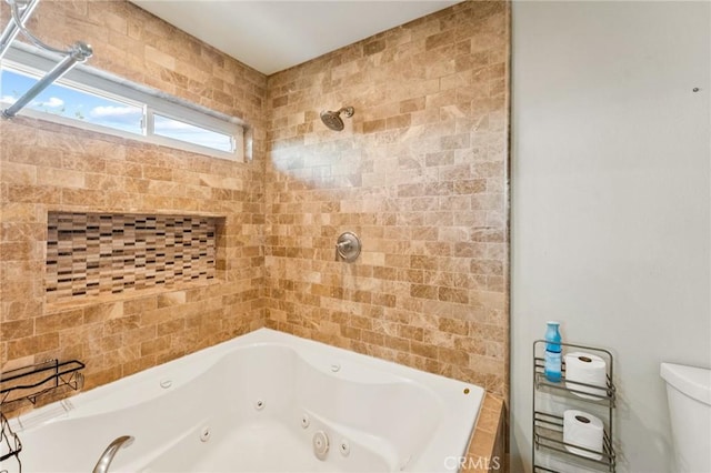 full bathroom featuring tiled shower, a jetted tub, and toilet