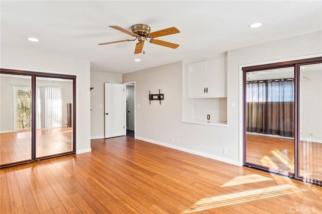 interior space featuring baseboards, recessed lighting, a ceiling fan, and light wood-style floors