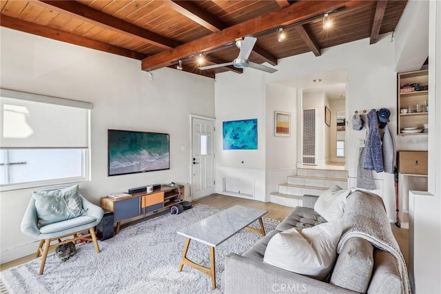 living area with beam ceiling, wooden ceiling, wood finished floors, and a ceiling fan