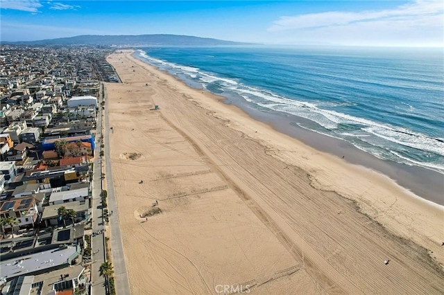 birds eye view of property featuring a water view and a beach view