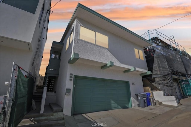 exterior space with a garage and stucco siding