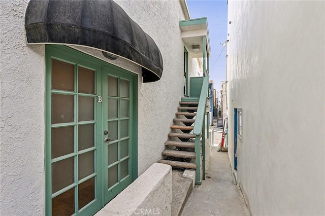 property entrance with stucco siding