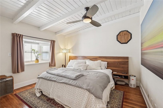 bedroom featuring beamed ceiling, wood finished floors, a ceiling fan, and baseboards