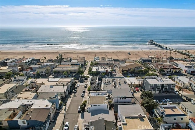 birds eye view of property featuring a water view and a beach view