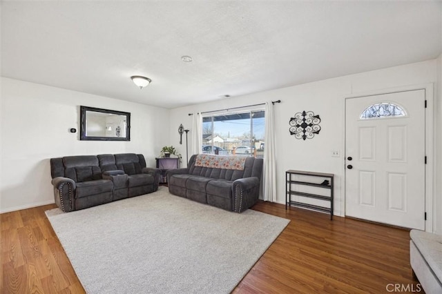 living area featuring baseboards and wood finished floors