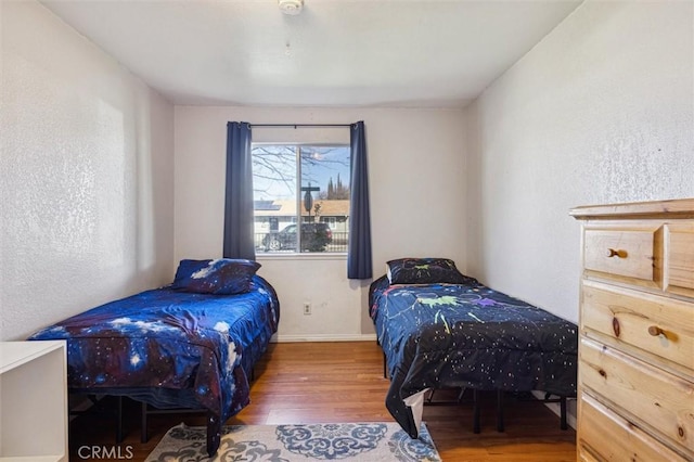 bedroom featuring wood finished floors