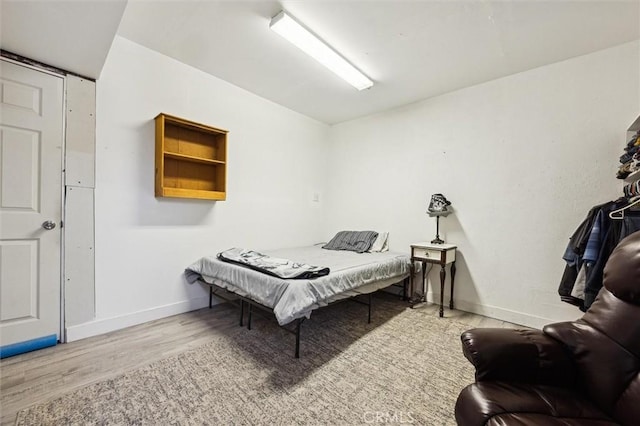 bedroom with baseboards and wood finished floors