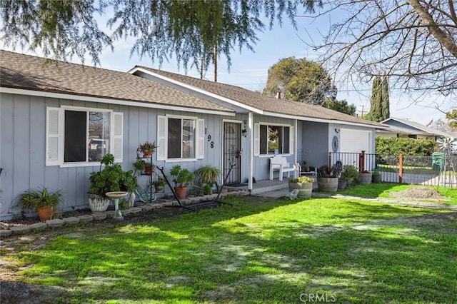 single story home with a garage, fence, a front lawn, and board and batten siding