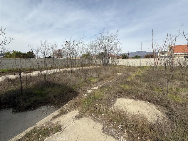 view of yard with a rural view and fence