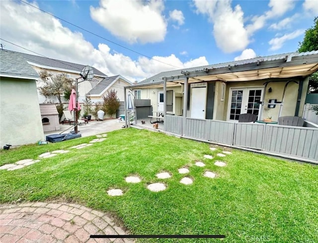 view of yard with a patio and french doors